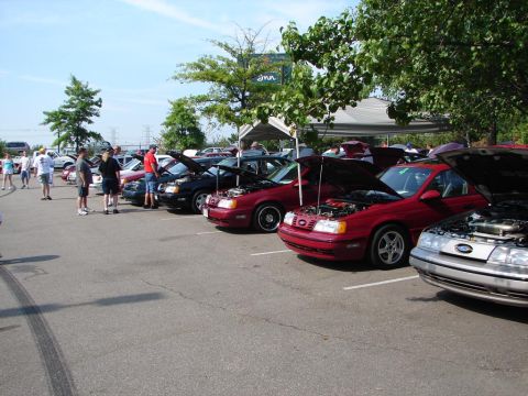 1992 Ford Taurus - A car show multiple Ford Taurus models, with owners displaying their vehicles.