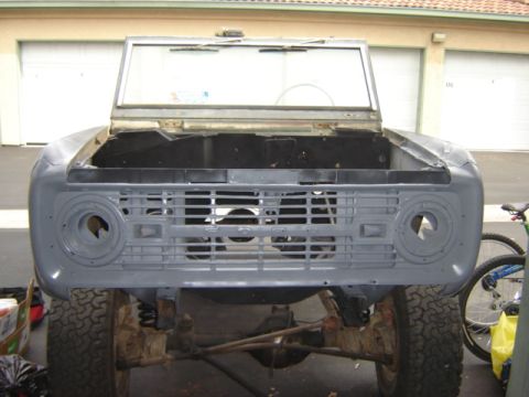 1971 Ford Bronco - Front view of a 1971 Ford Bronco undergoing restoration, showing the front clip in primer.