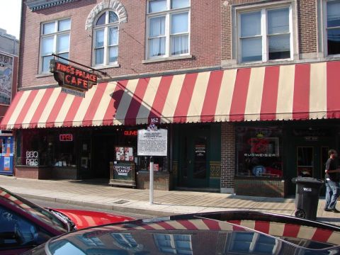 1992 Ford Taurus - A historical marker stands in front of the King's Palace Cafe, with vehicles partially visible in the foreground.