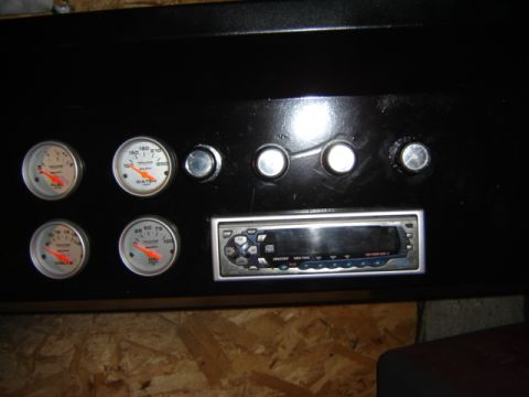1971 Ford Bronco - Custom dashboard features aftermarket gauges and a stereo system, with visible text on the gauges and stereo unit.