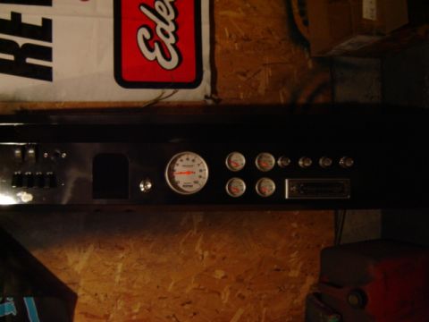 1971 Ford Bronco - Custom dashboard features a tachometer, multiple gauges, switches, and a vintage radio.