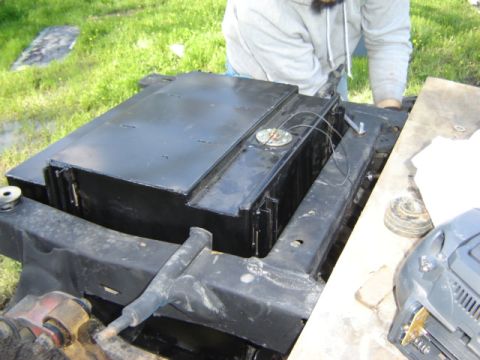 1971 Ford Bronco - A black fuel tank assembly is shown mounted to a vehicle frame, with wiring connected to the sender unit.