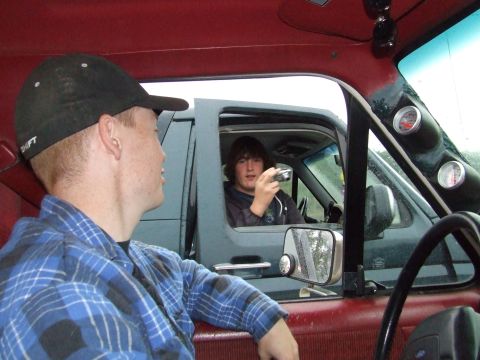 1990 Ford Bronco - Two people in separate vehicles, one taking a picture of the other.