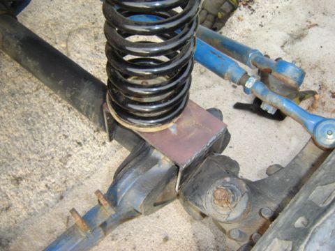 1971 Ford Bronco - Custom bracket installed on vehicle's front axle assembly near the coil spring.
