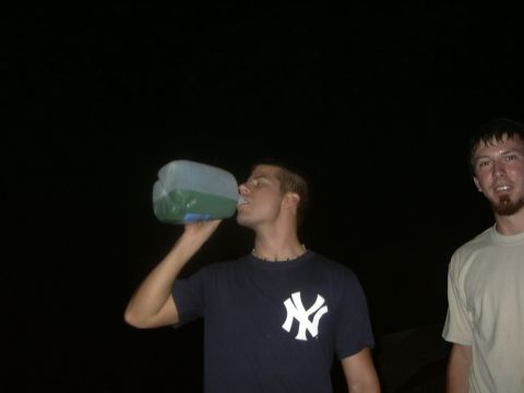 1995 Ford Probe - Two men are seen outdoors at night, with one drinking from a large jug.