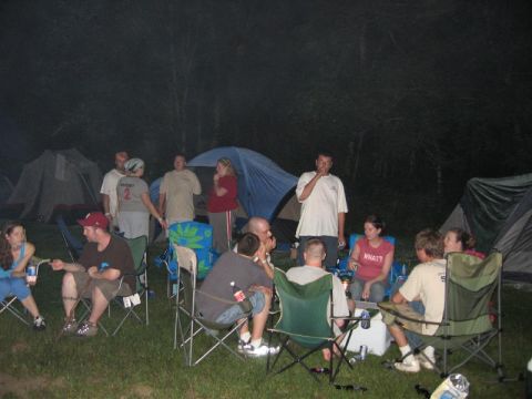 1995 Ford Probe - A group of friends enjoys a night of camping with tents pitched and a campfire glowing.