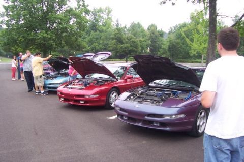 1995 Ford Probe - Several Ford Probes are displayed with their hoods open, their engines.