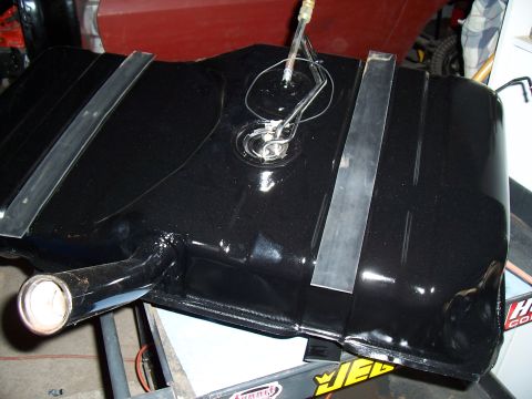 1979 Chevrolet Camaro - A black fuel tank with metal straps and a fuel sending unit is shown.