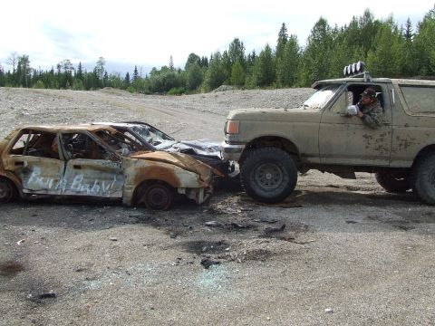 1990 Ford Bronco - A Ford Bronco appears to have pushed a heavily damaged and burnt sedan.