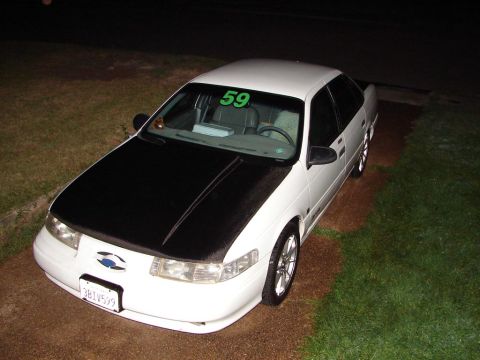 1992 Ford Taurus - This 1992 Ford Taurus has a black hood and a green number 59 sticker on the windshield.