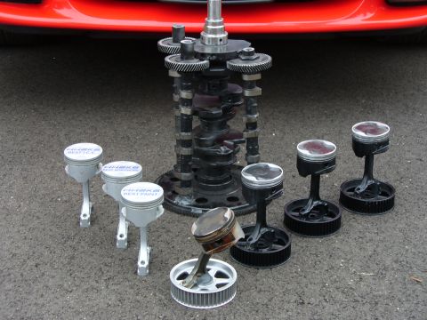 1991 Ford Probe - Engine components including crankshaft, camshafts, and pistons are arranged on the ground.