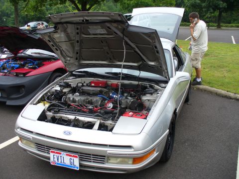 1991 Ford Probe - A silver 1991 Ford Probe is parked with its hood open, revealing the engine compartment.