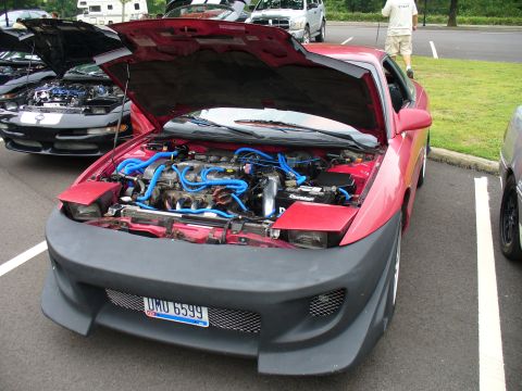 1991 Ford Probe - Front view of a red 1991 Ford Probe with its hood open, revealing the engine compartment.