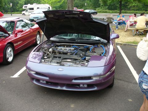 1991 Ford Probe - A purple 1991 Ford Probe is displayed with its hood open, revealing the engine compartment.