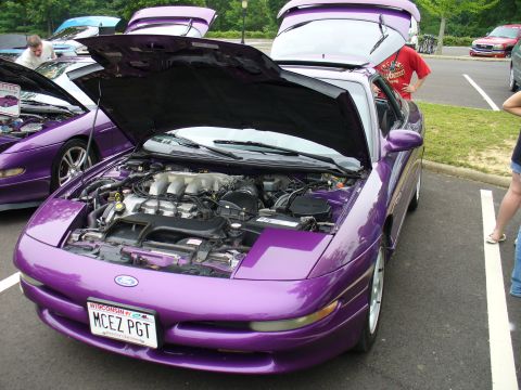 1991 Ford Probe - A purple 1993 Ford Probe is parked with its hood open, revealing the engine bay.
