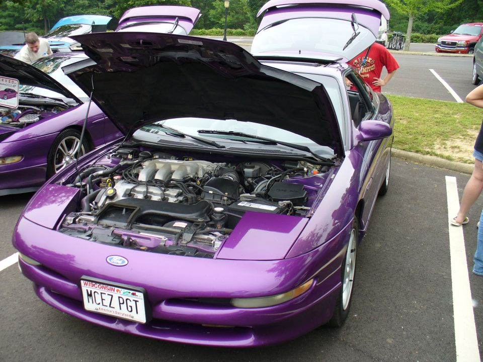 Purple 1993 Ford Probe, front view, hood open showing engine. License plate 'MCEZ PGT'