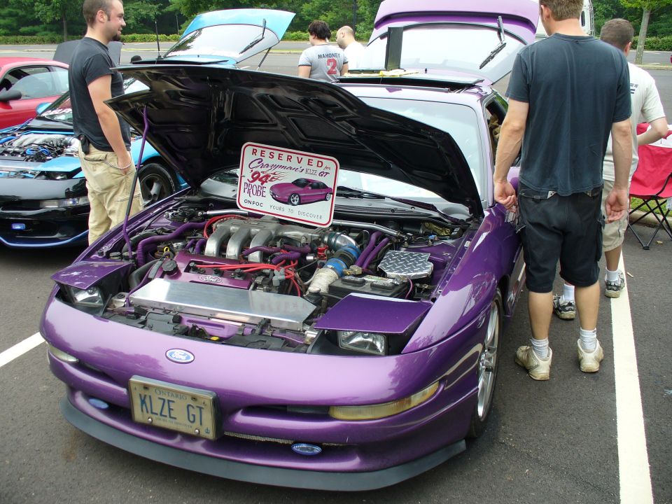 Purple 1994 Ford Probe GT with hood open, showing custom engine modifications