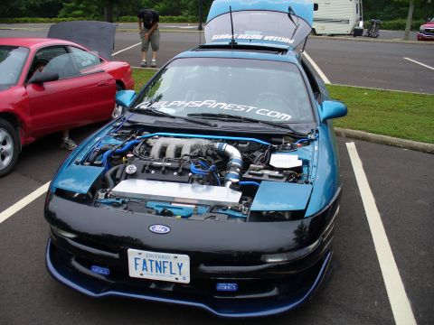 1991 Ford Probe - A blue 1991 Ford Probe is displayed with its hood open, revealing the engine bay.