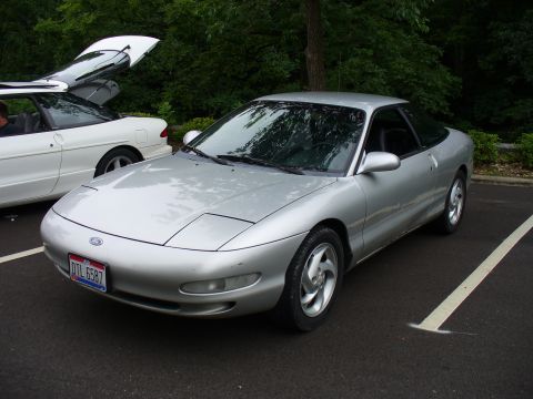 1991 Ford Probe - A silver 1991 Ford Probe is parked in a lot, with its front end angled towards the viewer.
