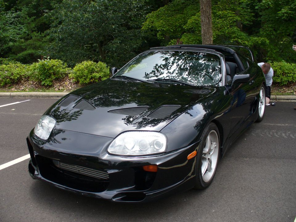 Black Toyota Supra with aftermarket hood vents and front bumper