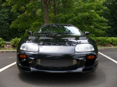 1991 Ford Probe - Front view of a black Toyota Supra, a sports car with distinctive hood scoops and an exposed intercooler.