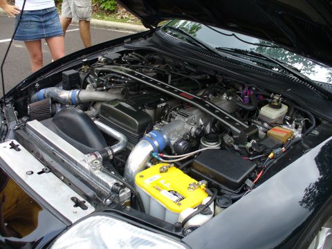 1991 Ford Probe - Customized engine bay aftermarket parts and a yellow Optima battery.