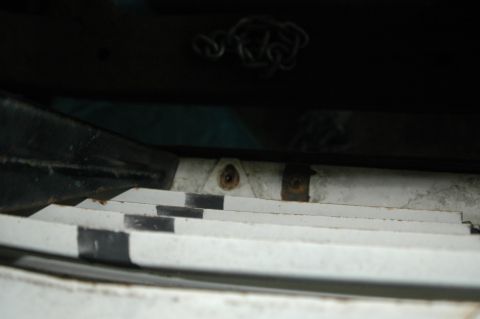 1963 Ford F-250 - A close-up view of a truck bed's tie-down anchor, showing some rust and wear.