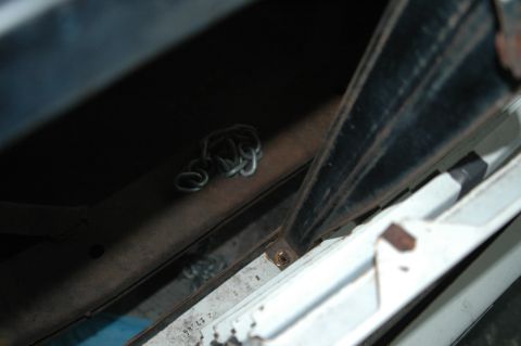 1963 Ford F-250 - Close-up view of a metal chain and structural components, with some faint text visible on a white surface.