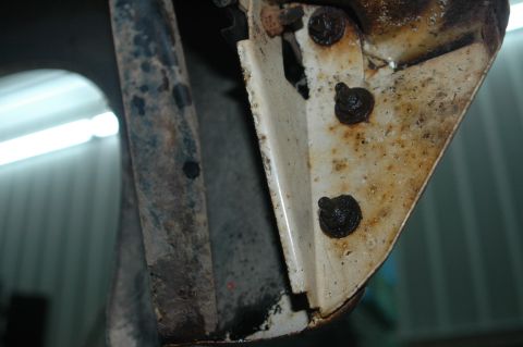 1963 Ford F-250 - Detail of a corroded metal bracket and fasteners, likely from a vehicle's disassembly.