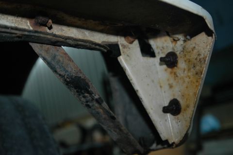 1963 Ford F-250 - Close-up of a rusted metal bracket and frame, likely from a vehicle's undercarriage.