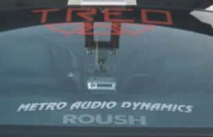 2001 Ford Mustang - Decals on the rear window of a vehicle, including ROUSH branding.