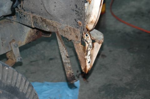 1963 Ford F-250 - Close-up of a heavily rusted fender bracket and associated hardware from a disassembled vehicle.