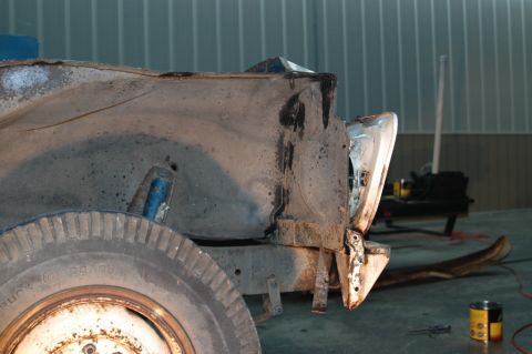 1963 Ford F-250 - The rear quarter panel and wheel well of a heavily rusted truck are shown in this side view.