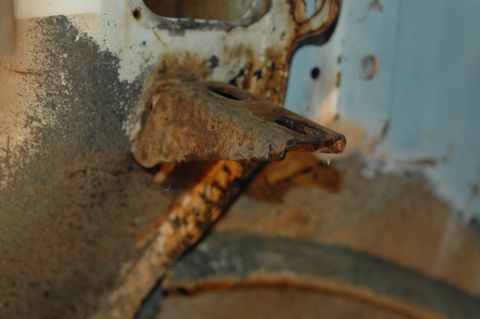 1963 Ford F-250 - Close-up of a rusted metal bracket on a vehicle frame, likely from a donor disassembly.