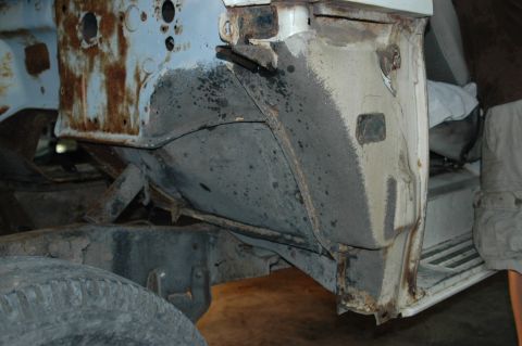 1963 Ford F-250 - Close-up of the rusted frame and wheel well area on a 1963 Ford F-250.
