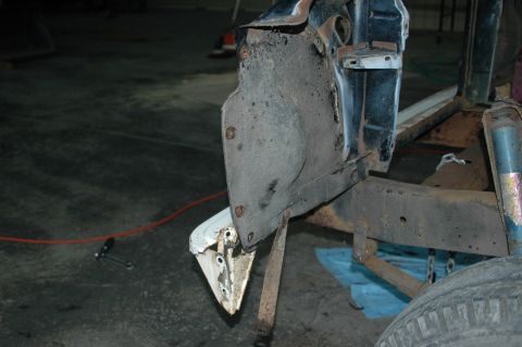 1963 Ford F-250 - Close-up of a disassembled truck's rusty frame and fender well area, indicating significant wear and tear.
