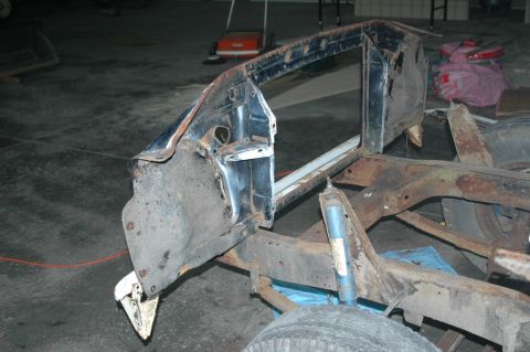 1963 Ford F-250 - Frame and fender section of a 1963 Ford F-250 undergoing disassembly.
