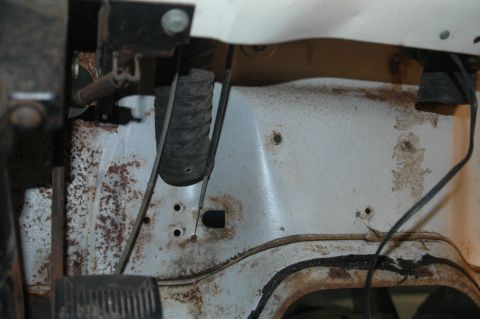1963 Ford F-250 - Close-up view of the interior firewall and pedals, showing significant rust and wear.