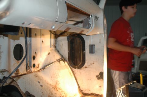 1963 Ford F-250 - The interior of a truck cab shows signs of wear and tear, with exposed metal and rust visible.