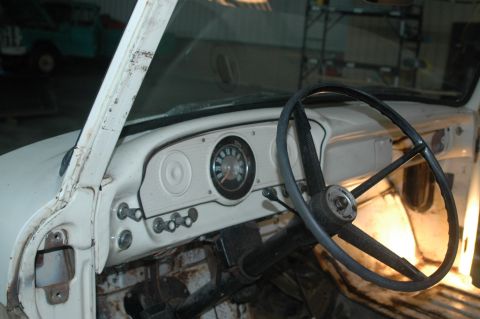 1963 Ford F-250 - The interior of a vintage truck shows a simple dashboard with a central gauge cluster and a large steering wheel.