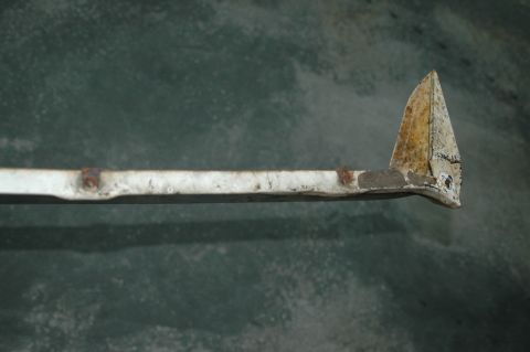 1963 Ford F-250 - A close-up view of a weathered metal trim piece, showing signs of age and wear.