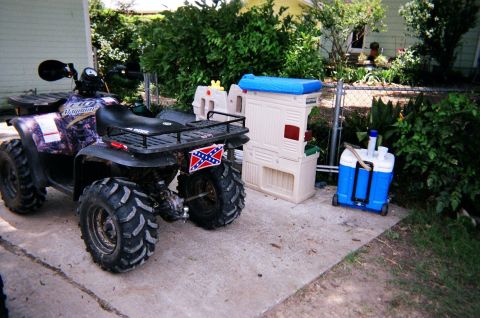 1995 Ford Bronco - This ATV is parked on a concrete pad next to outdoor storage and a cooler. The registry incorrectly identified it as a 1995 Ford Bronco.