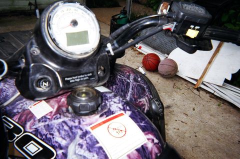 1995 Ford Bronco - Close-up of an ATV's dashboard and handlebars, with two basketballs in the background.