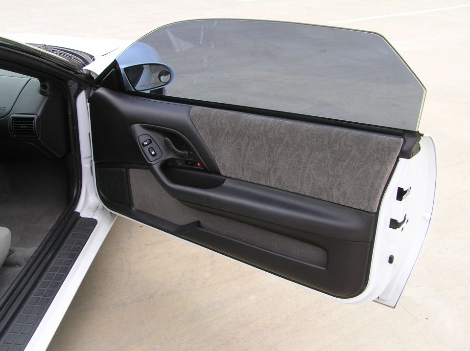 2001 Chevrolet Camaro driver's side door interior with black leather and grey fabric panel