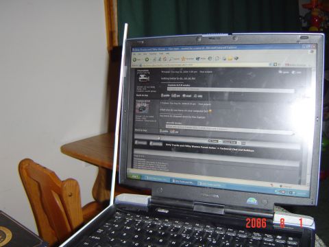 2005 Dodge 1500 - A laptop displays a web forum with multiple posts and user interactions.