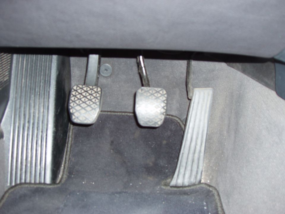 Interior footwell of a 1993 BMW 3 Series showing clutch, brake, and accelerator pedals