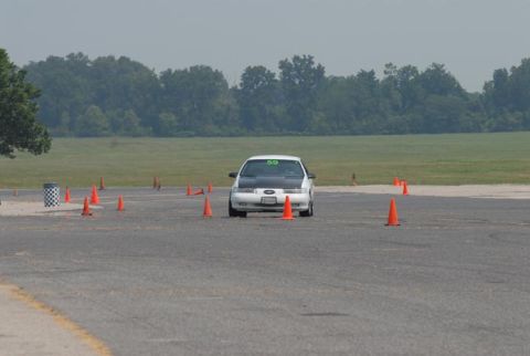 1992 Ford Taurus - A 1992 Ford Taurus navigates a course marked by orange cones on a paved track.