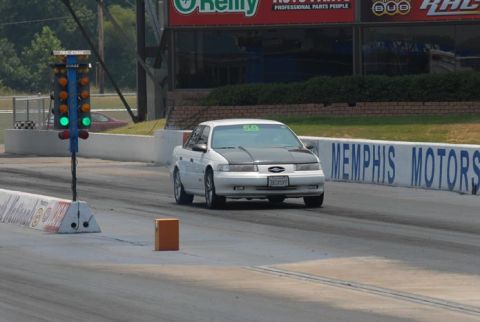 1992 Ford Taurus - A white Ford Taurus with a black hood is on the drag strip, with the Memphis Motors sign visible.