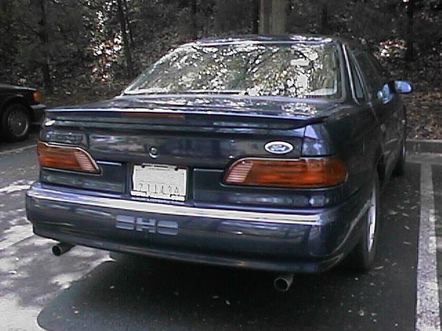 Dark blue sedan rear view, license plate 73112A, SHO badging