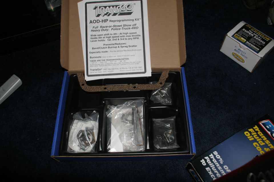 TransGo AOD-HP transmission reprogramming kit box with parts, servo box and B&M cooler